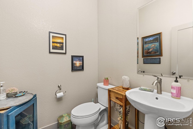 bathroom with toilet and sink