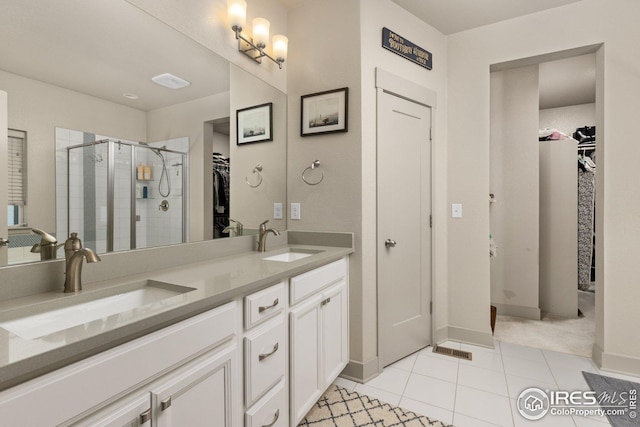 bathroom featuring vanity, an enclosed shower, and tile patterned floors