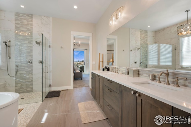 bathroom featuring double vanity, a sink, recessed lighting, and a shower stall