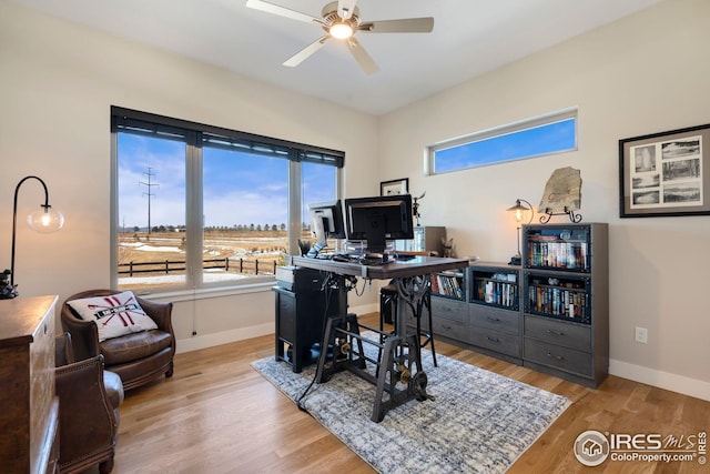 office area featuring baseboards, a ceiling fan, and wood finished floors