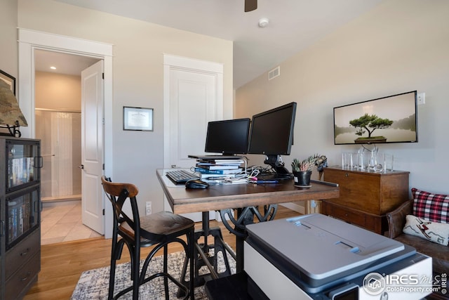 home office with ceiling fan, visible vents, and light wood-style floors