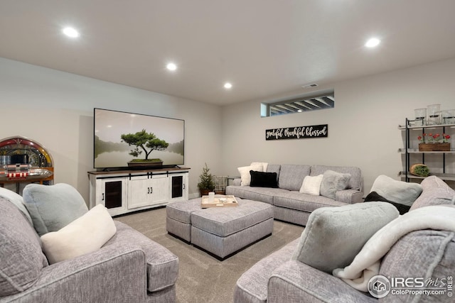 living area with recessed lighting and light colored carpet