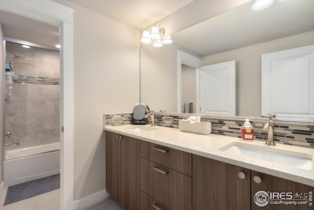 full bath featuring a sink, baseboards, backsplash, and double vanity