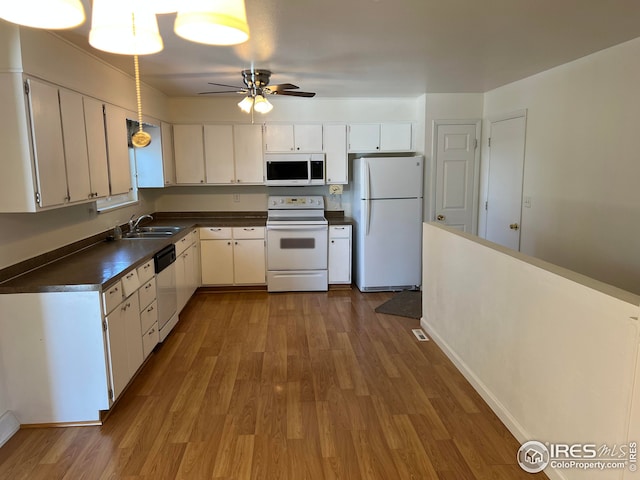 kitchen featuring sink, white appliances, ceiling fan, white cabinetry, and light hardwood / wood-style floors