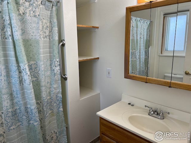 bathroom with vanity, a shower with curtain, and toilet