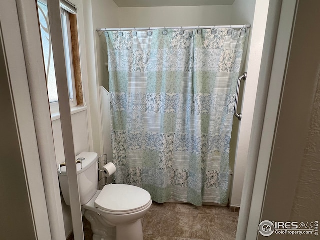 bathroom with walk in shower and toilet