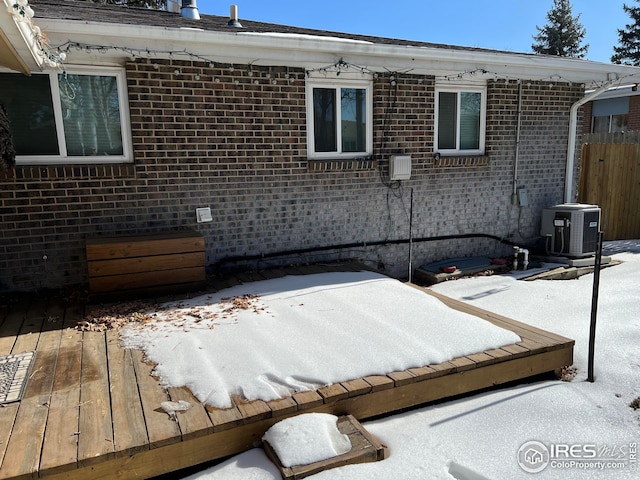 exterior space featuring central AC unit and a deck