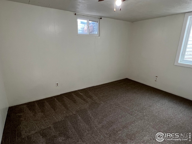 carpeted spare room featuring ceiling fan