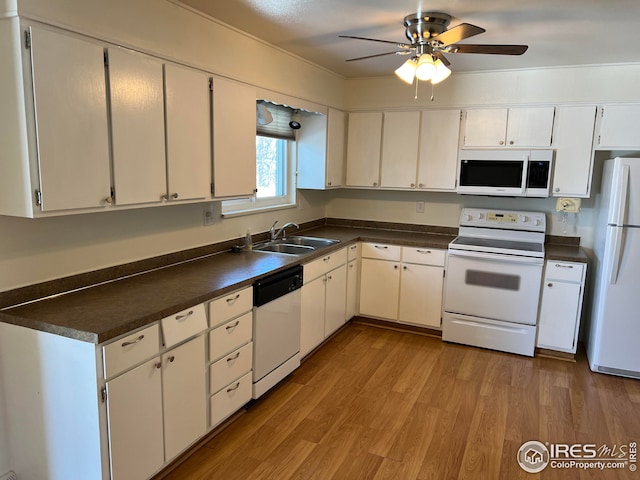 kitchen featuring white cabinetry, sink, white appliances, and light wood-type flooring