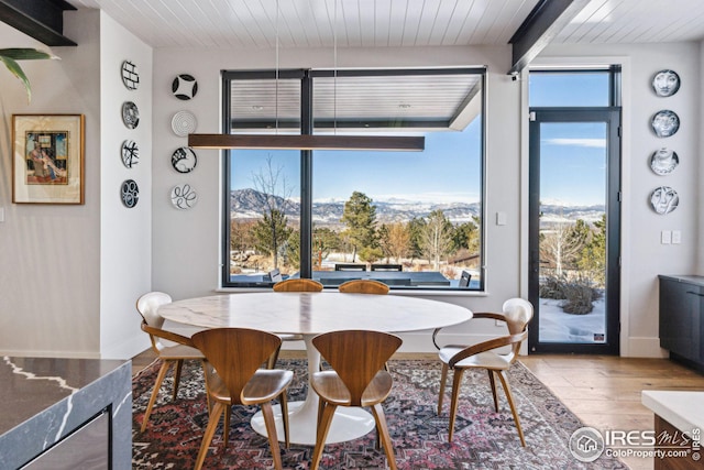 635 Paragon Dr, Boulder, CO 80303 - dining area featuring wood finished floors, a wooden ceiling with exposed beams, and a mountain view