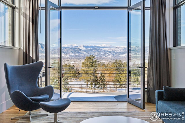 635 Paragon Dr, Boulder, CO 80303 - sitting room featuring healthy amount of natural light, a mountain view, wood finished floors, and floor to ceiling windows