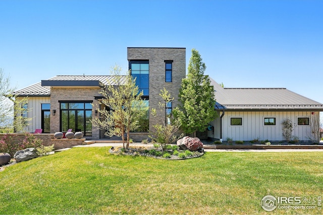 635 Paragon Dr, Boulder, CO 80303 - rear view of property featuring board and batten siding, a metal roof, a yard, and a standing seam roof
