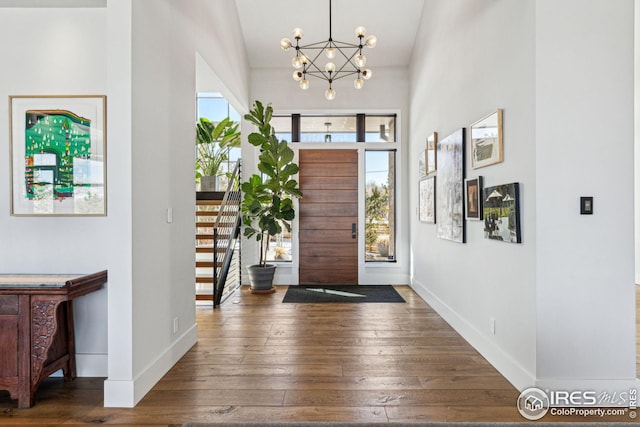 635 Paragon Dr, Boulder, CO 80303 - foyer featuring a chandelier, hardwood / wood-style flooring, a towering ceiling, and stairs