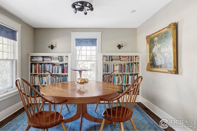 dining space with dark hardwood / wood-style floors