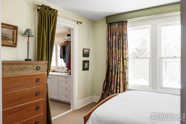 carpeted bedroom with connected bathroom