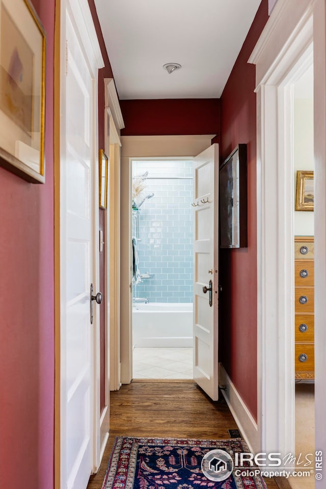 hallway with hardwood / wood-style floors