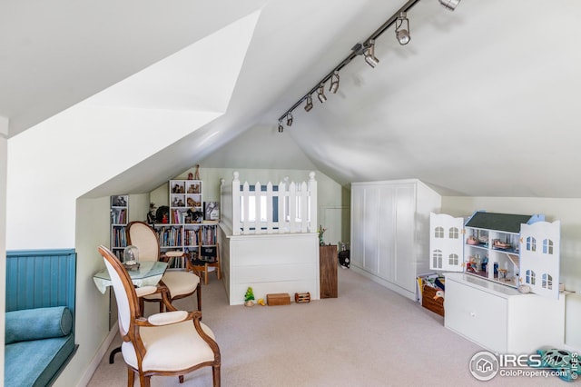 living area featuring lofted ceiling, light carpet, and track lighting