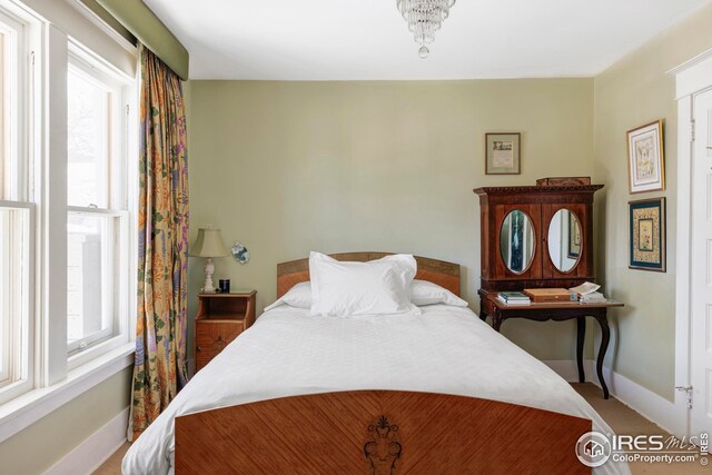 bedroom with baseboards and carpet floors