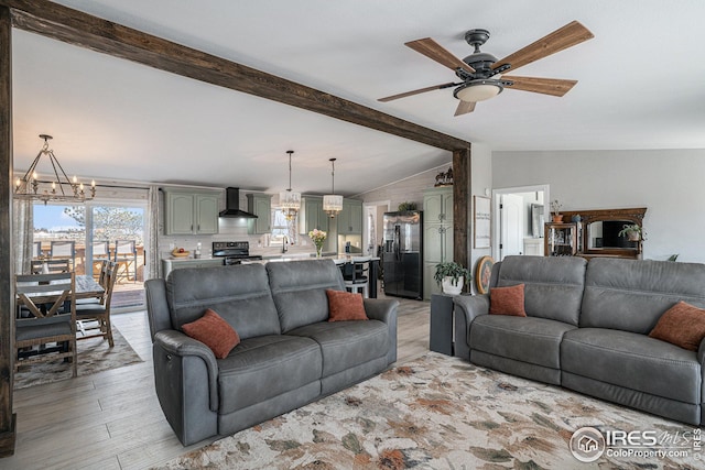 living room featuring sink, ceiling fan with notable chandelier, light hardwood / wood-style flooring, and vaulted ceiling with beams