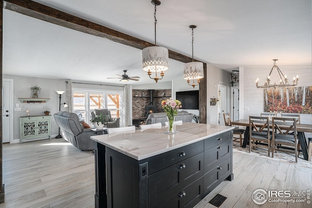 kitchen featuring pendant lighting, light hardwood / wood-style floors, and a center island