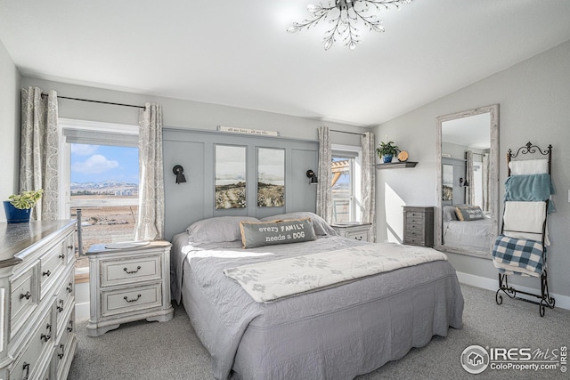 bedroom with lofted ceiling and light carpet