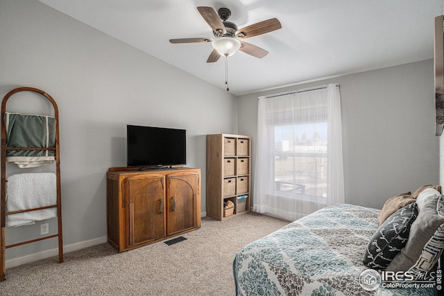 bedroom with vaulted ceiling, light colored carpet, and ceiling fan