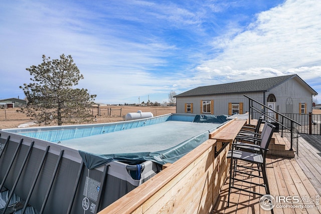 view of swimming pool with a jacuzzi and a deck