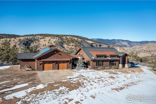 view of front of property featuring a garage and a mountain view