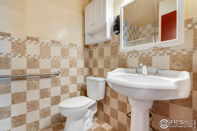 bathroom with tile walls and toilet