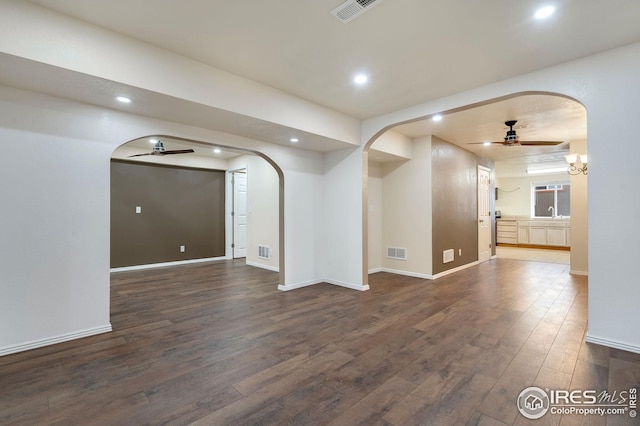 empty room featuring ceiling fan and dark hardwood / wood-style flooring