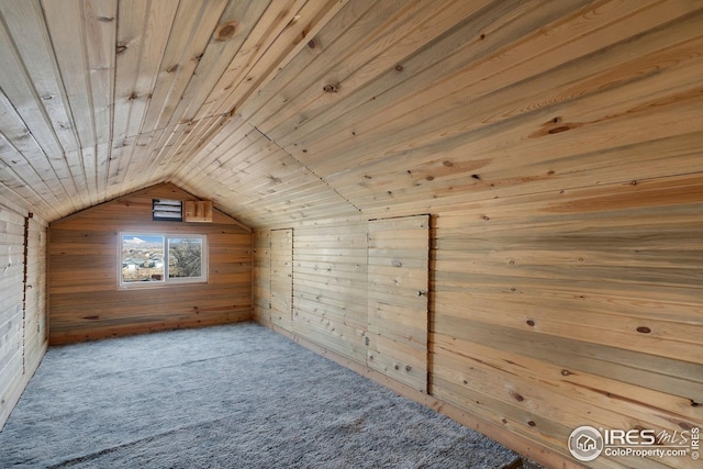 additional living space with lofted ceiling, carpet flooring, wood ceiling, and wood walls