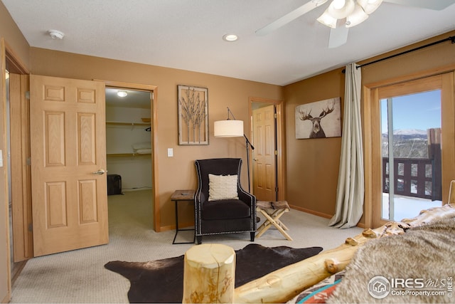 sitting room with ceiling fan and light carpet