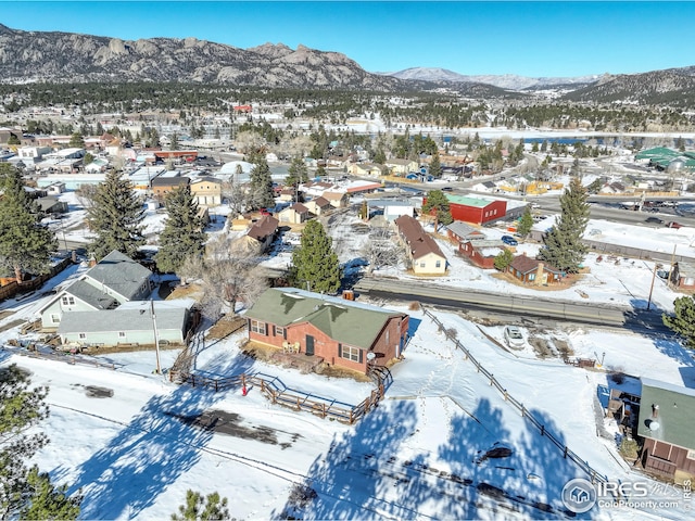 snowy aerial view featuring a mountain view