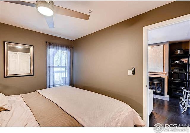 bedroom featuring dark hardwood / wood-style floors and ceiling fan