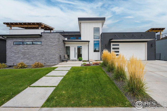 modern home with driveway, a front lawn, board and batten siding, and an attached garage