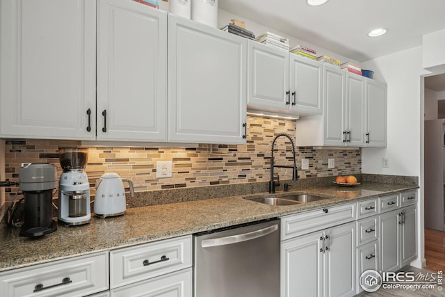 kitchen with stainless steel dishwasher, sink, and white cabinets