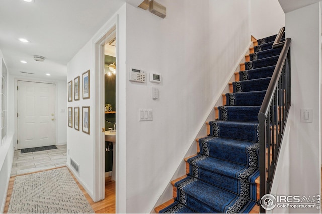 staircase with wood-type flooring