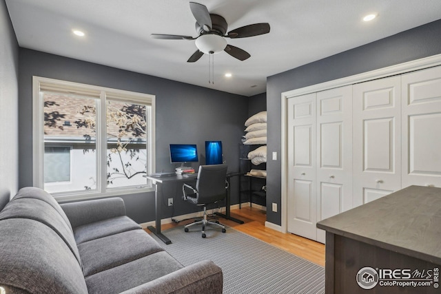 office with ceiling fan and light hardwood / wood-style flooring