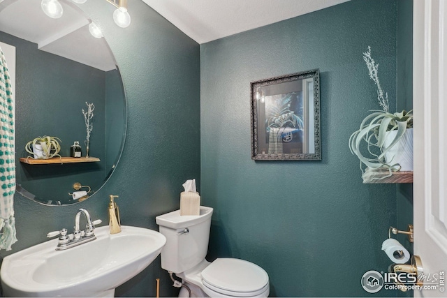 bathroom with sink and toilet