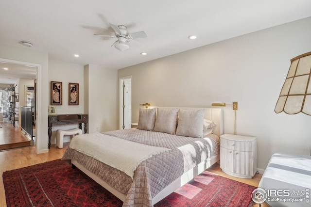 bedroom with light hardwood / wood-style flooring and ceiling fan