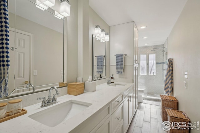 bathroom featuring vanity, an enclosed shower, and toilet