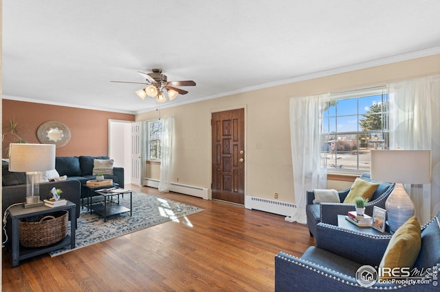 living room with crown molding, hardwood / wood-style flooring, and a baseboard radiator