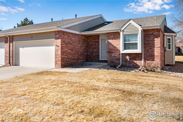 ranch-style house featuring a garage and a front lawn