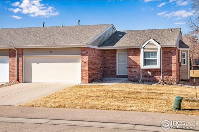 ranch-style home featuring a garage and a front lawn