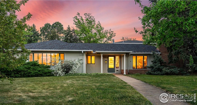 ranch-style house with a yard