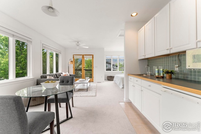 kitchen featuring tasteful backsplash, white appliances, sink, and white cabinets