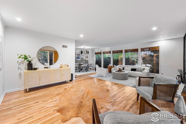 living room featuring wood-type flooring and ornamental molding