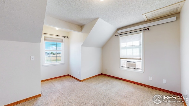 bonus room featuring cooling unit, carpet flooring, vaulted ceiling, and a textured ceiling