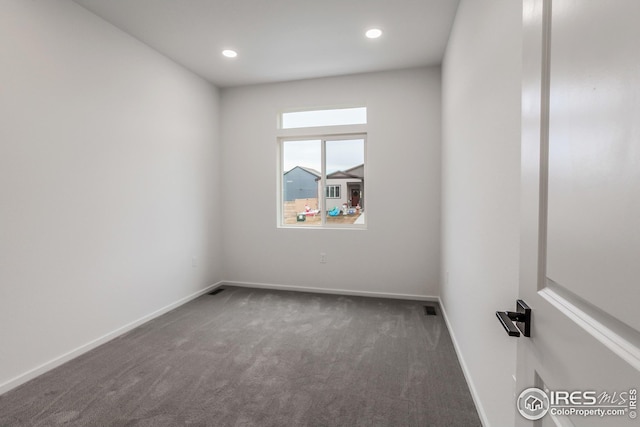 empty room featuring dark colored carpet