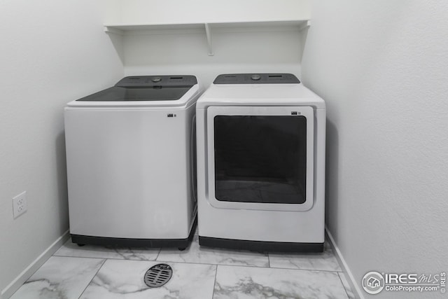 clothes washing area with washing machine and clothes dryer